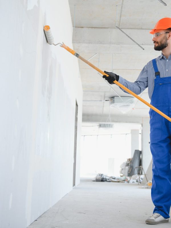 painter man painting the wall, with paint roller